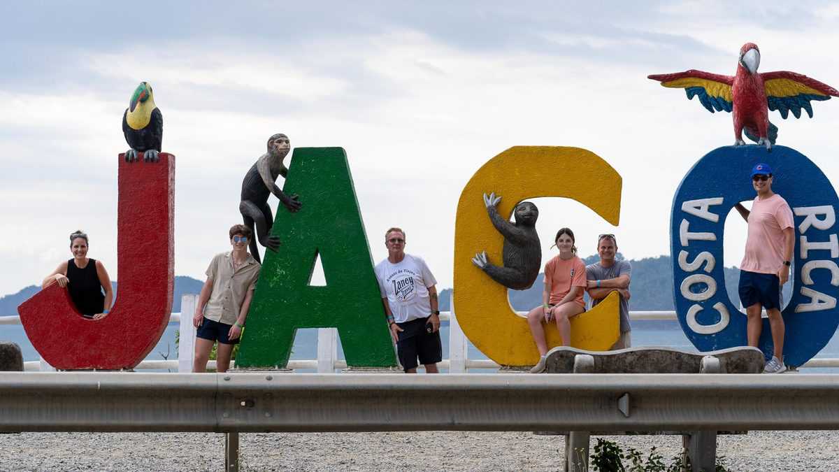 Group standing in front of the Jaco sign in Costa Rica.