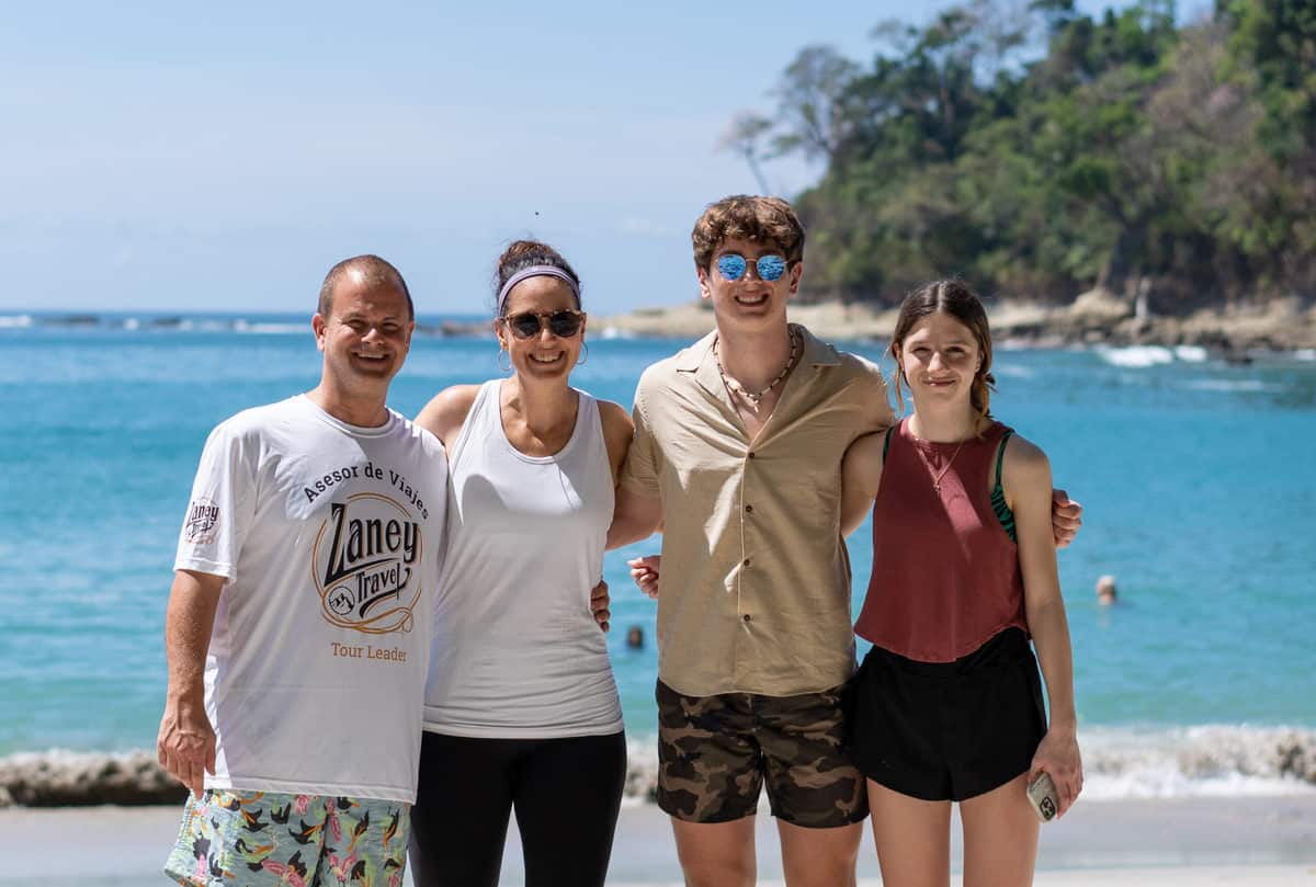 Family on beach at Manuel Antonio Park.