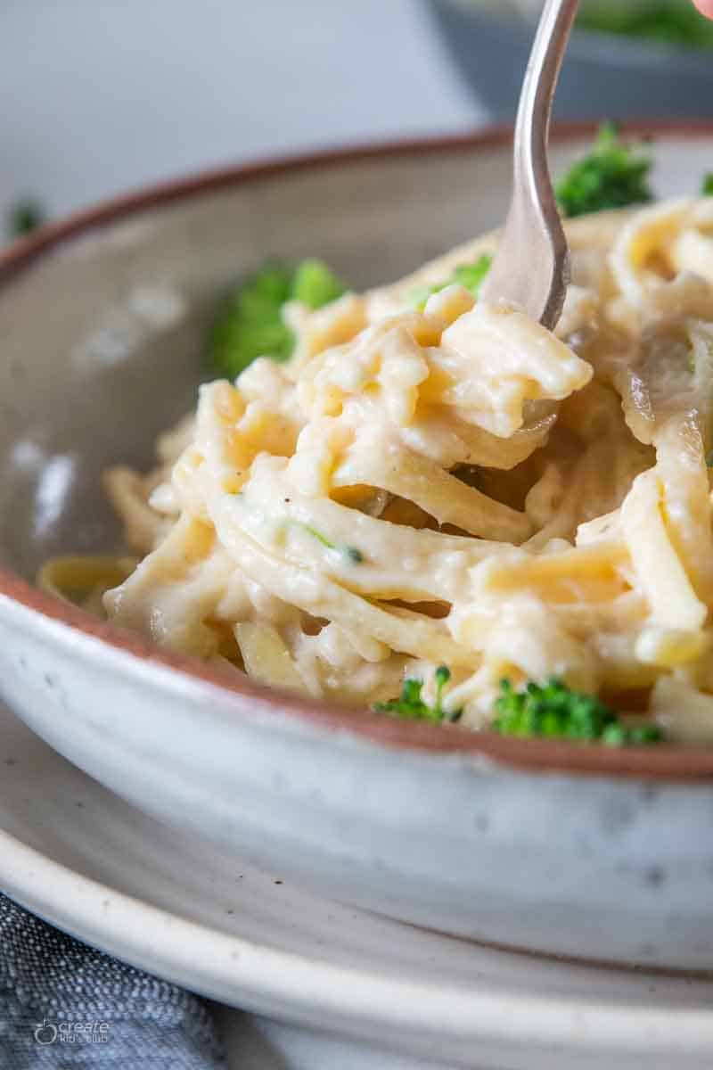 fork scooping pasta from bowl