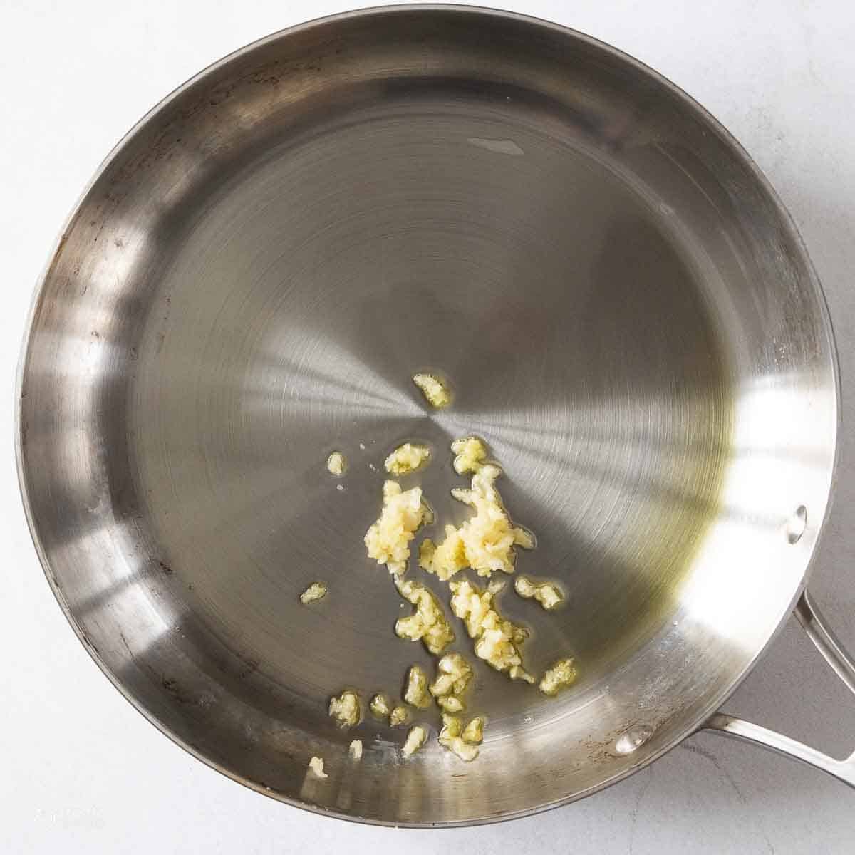 minced garlic in pan with oil