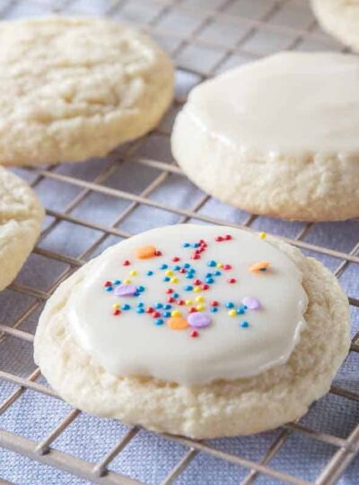 sugar cookie topped with icing and sprinkles