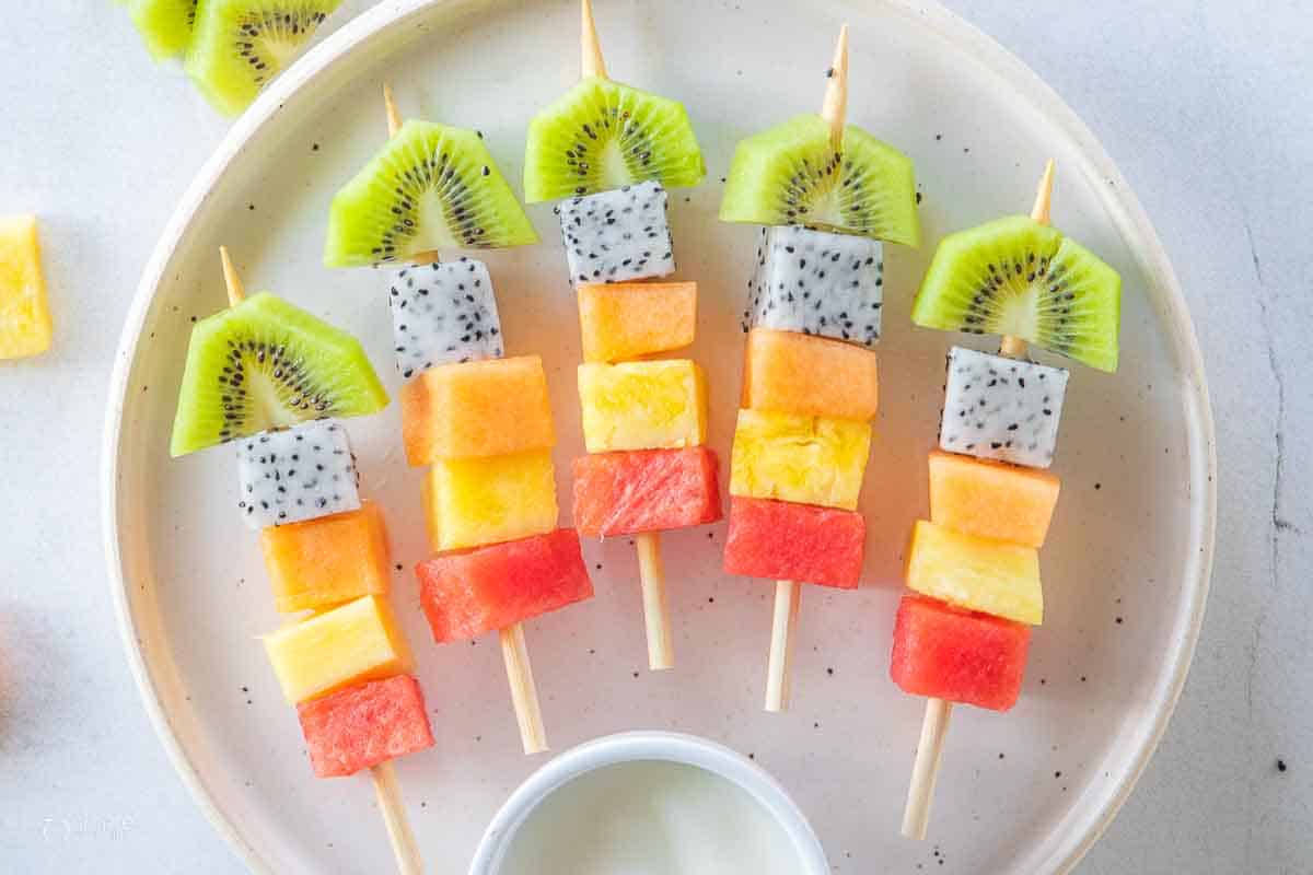 top down view of fruit skewers on plate