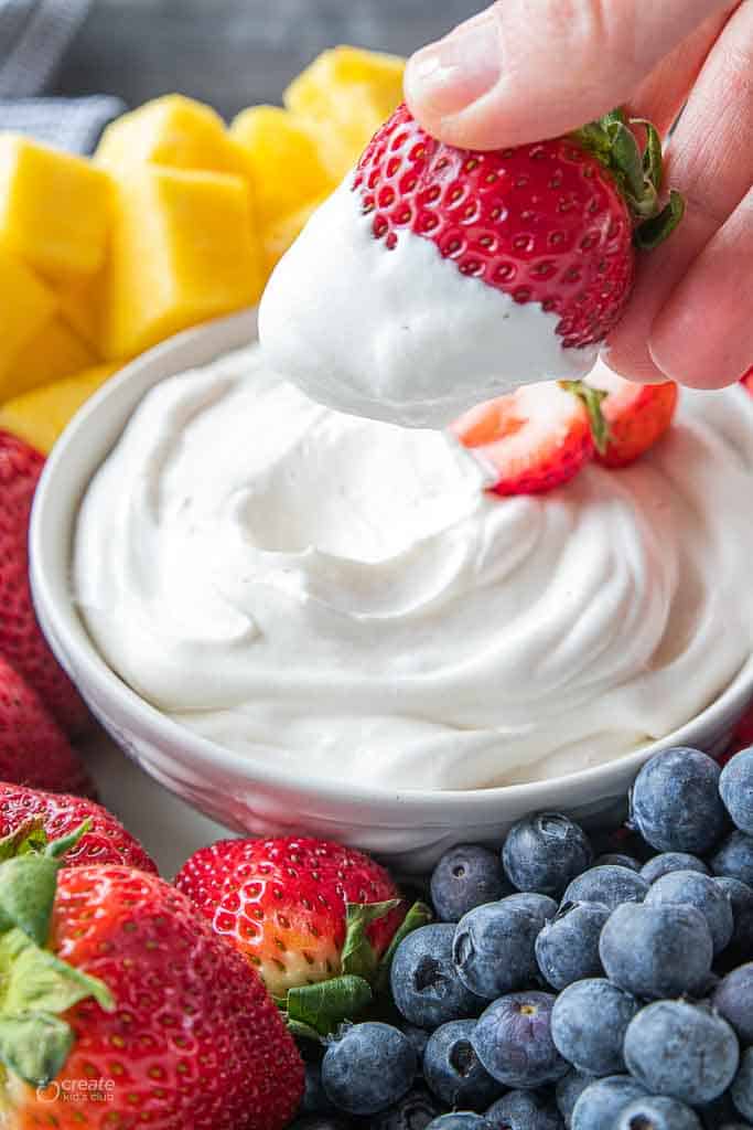 strawberry dipped into fruit dip
