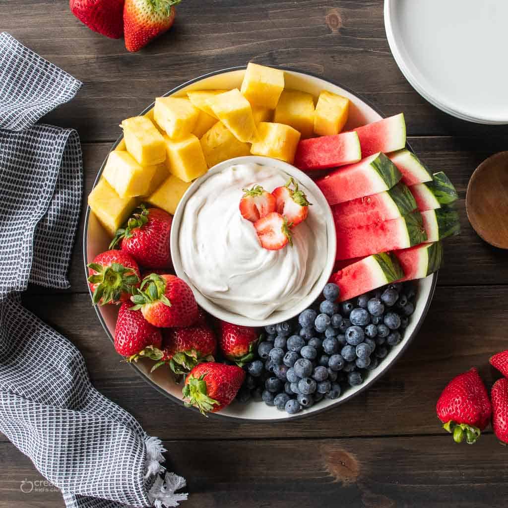 fresh fruit platter with fruit dip in the center
