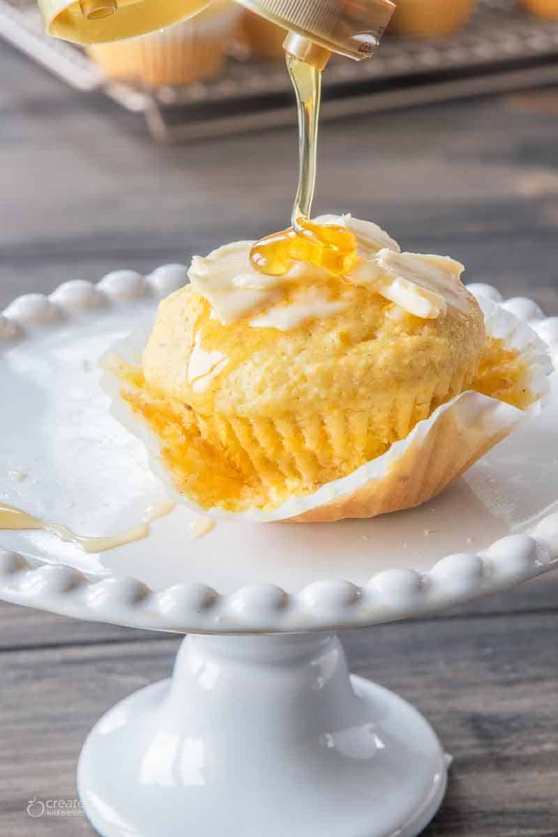 corn bread muffin spread with butter and drizzled with honey