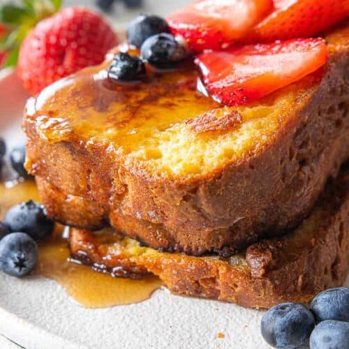 stacked gf French toast topped with fruit and berries