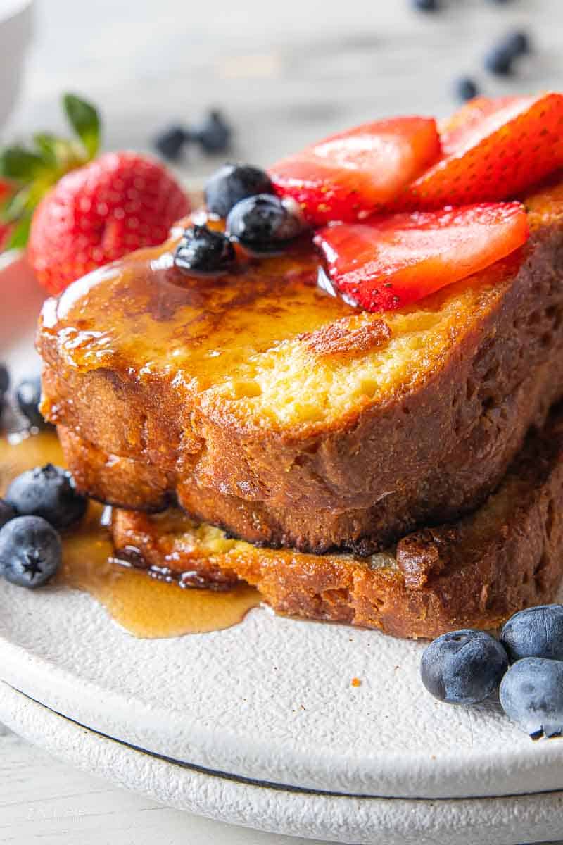 stacked gf French toast topped with fruit and berries