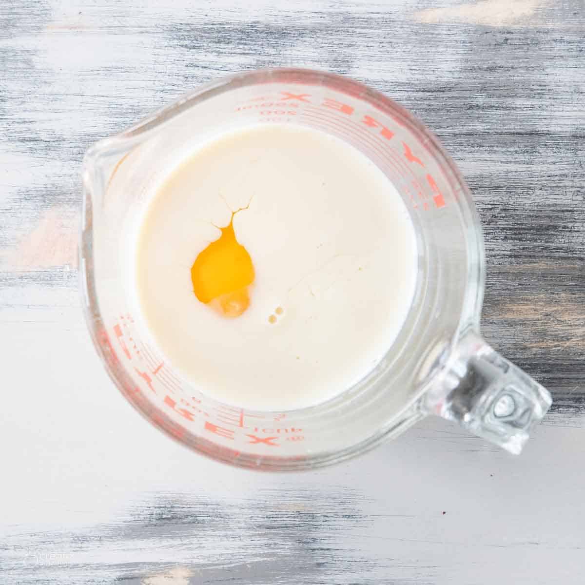 egg in measuring cup filled with soy milk