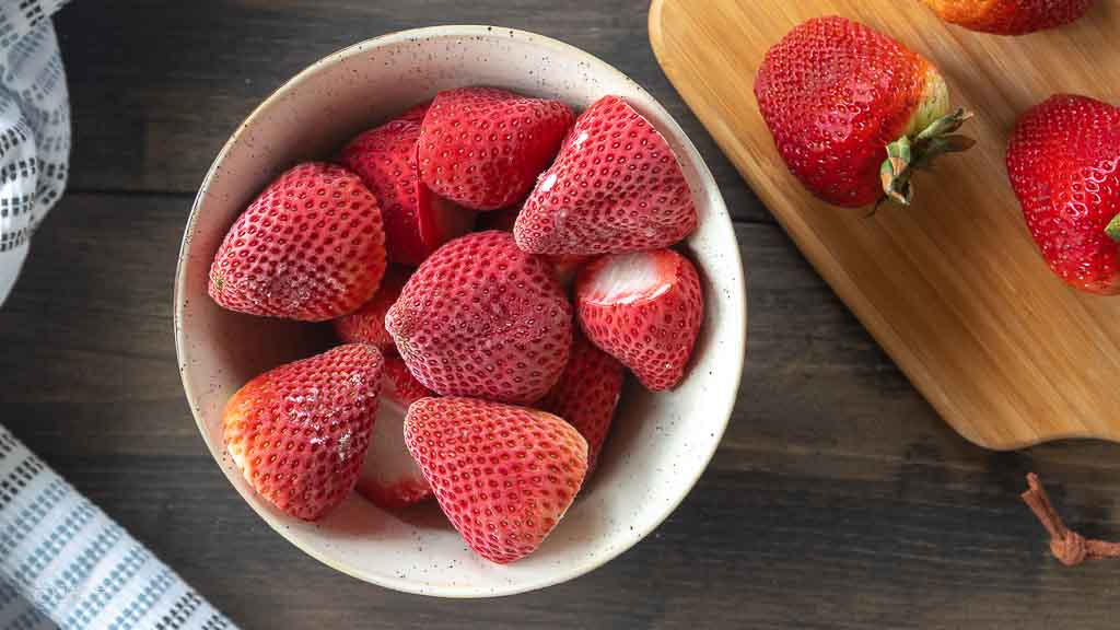 top down view of whole frozen strawberries in bowl