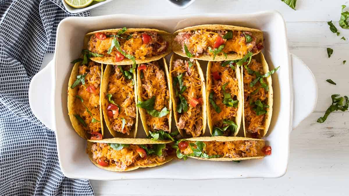 oven baked tacos topped with shredded lettuce