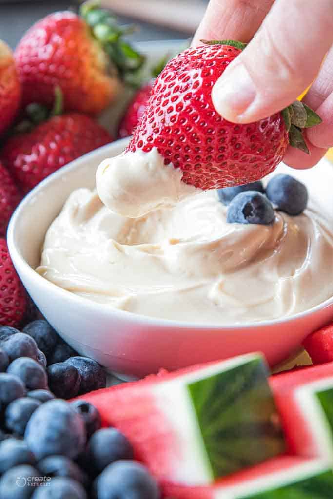 strawberry dipped into yogurt fruit dip