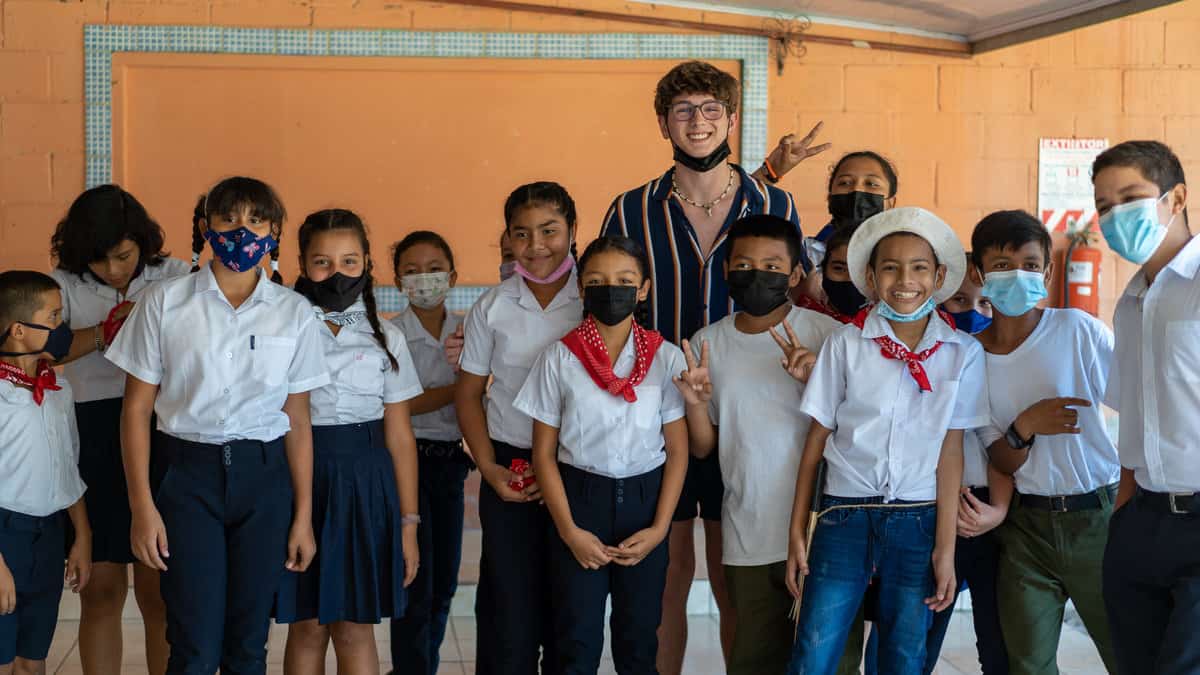 American teen boy with Costa Rican school kids.