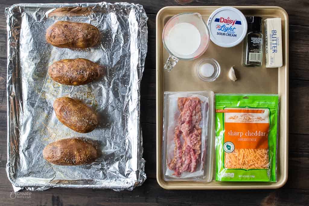 ingredients for twice baked potatoes on sheet pan