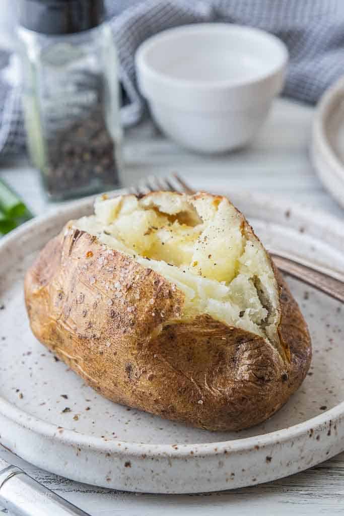 air fried baked potato topped with salt and butter