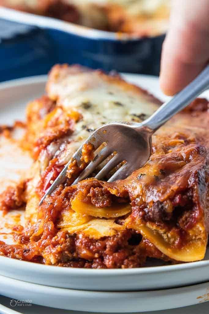 fork scooping into slice of gluten free lasagna