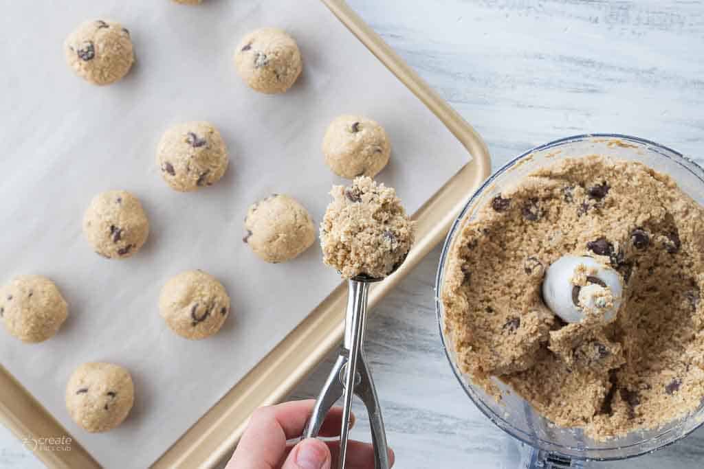 cookie dough bites scooped onto parchment lined sheet pan