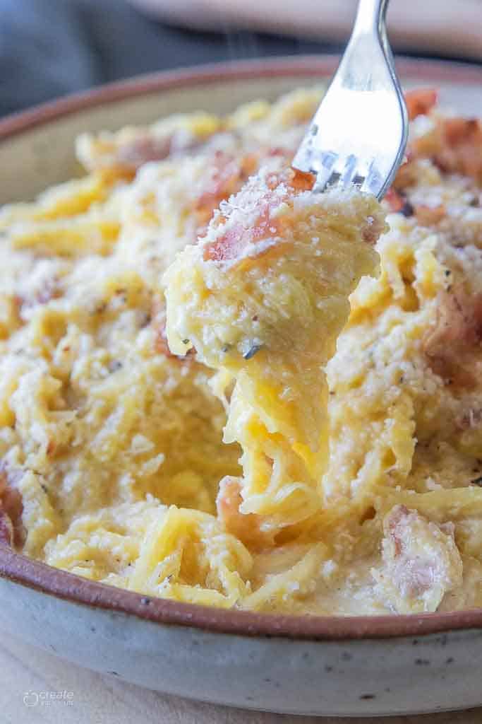 fork scooping into bowl of spaghetti squash carbonara