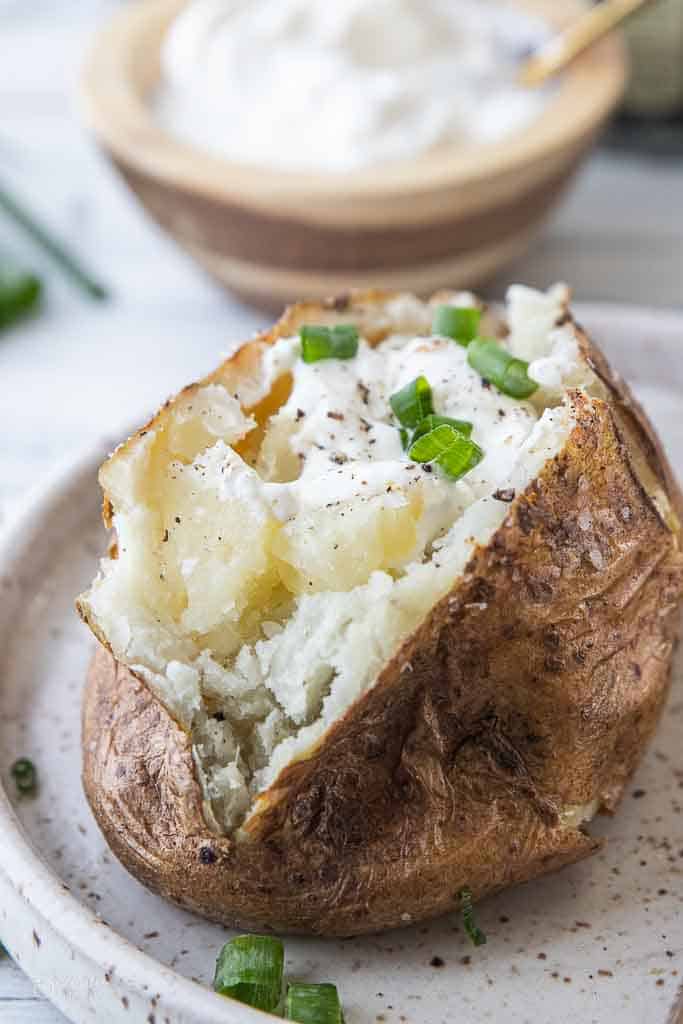 steakhouse baked potato topped with sour cream, butter and chives