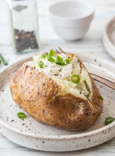 steakhouse baked potato with toppings on plate