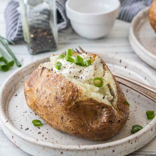 steakhouse baked potato with toppings on plate