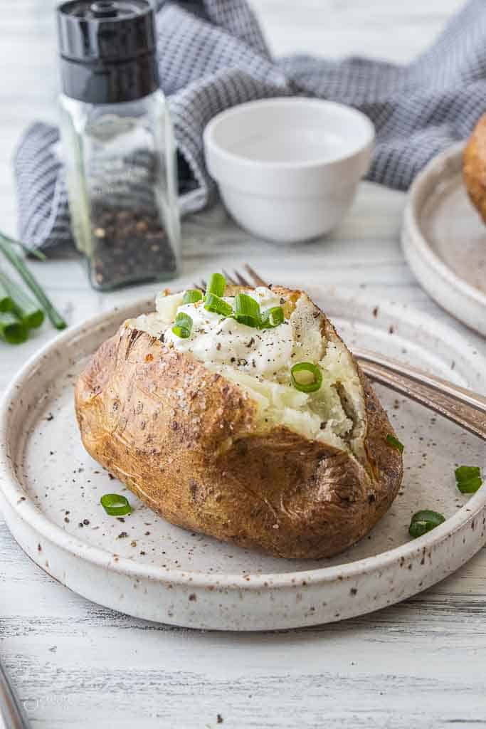 steakhouse baked potato with toppings on plate