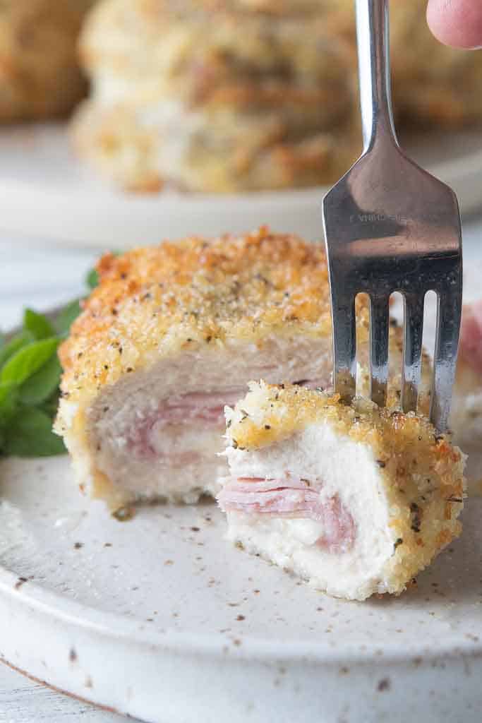 fork scooping bite of chicken cordon bleu