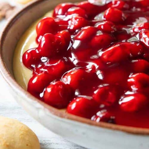 Cherry cheesecake dip shown up close in a bowl.