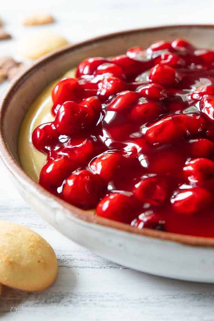 Cherry cheesecake dip shown up close in a bowl.
