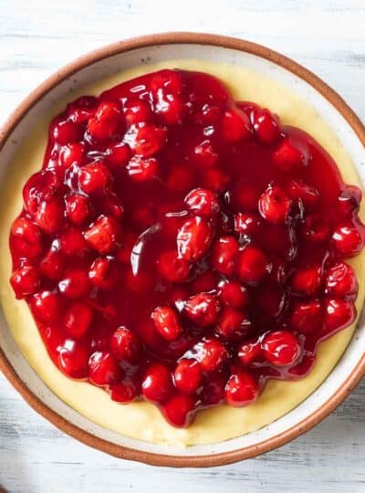 Cherry cheesecake dip shown in a ceramic bowl.