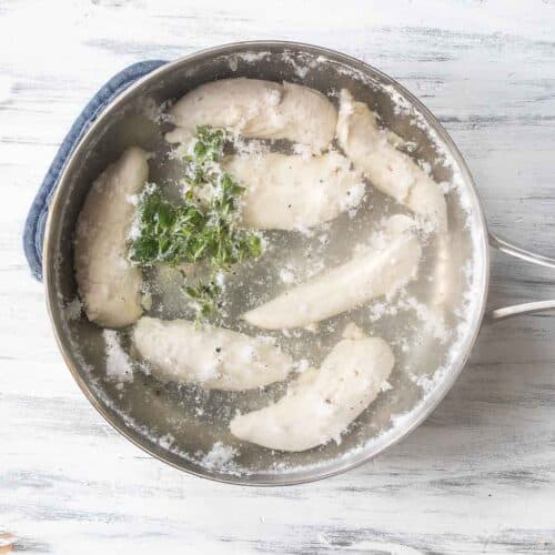 chicken tenders boiling in pot of water