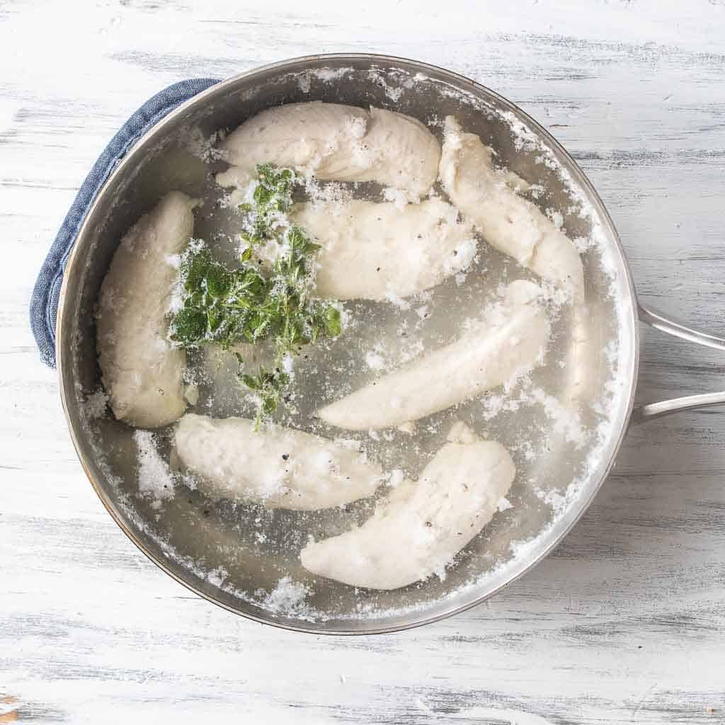 chicken tenders boiling in pot of water