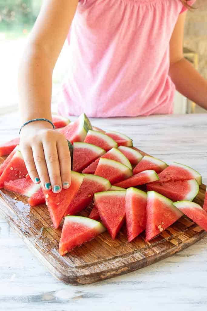 hand picking up watermelon slice