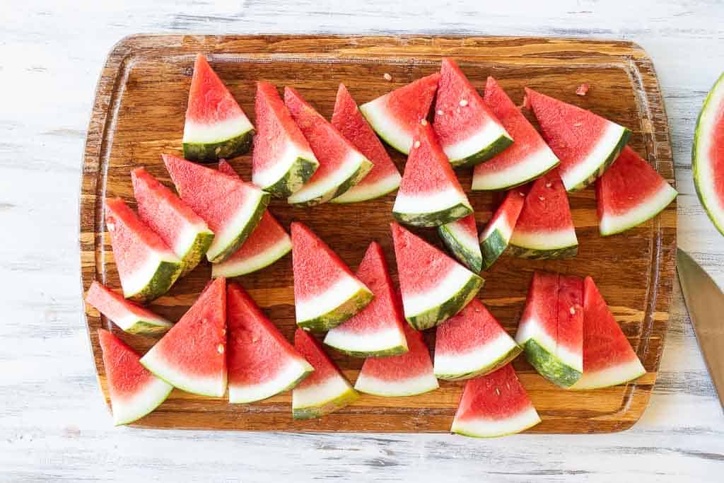 top down view of watermelon slices on a cutting board