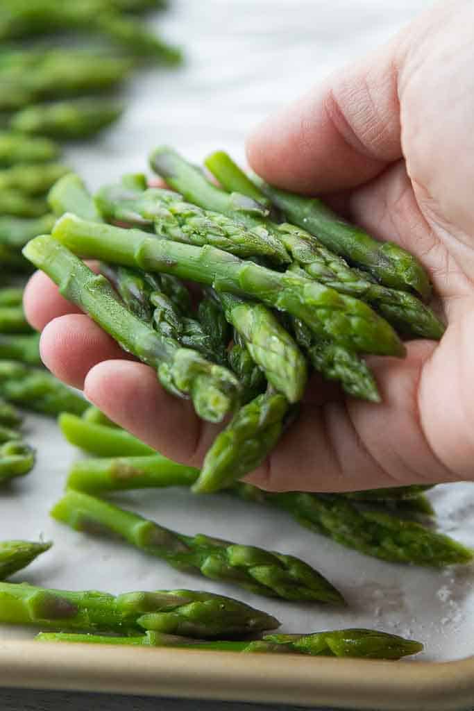 hand holding frozen asparagus