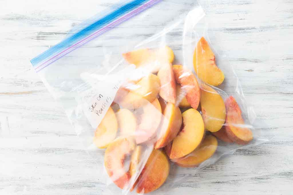 frozen peach slices in a Ziploc bag