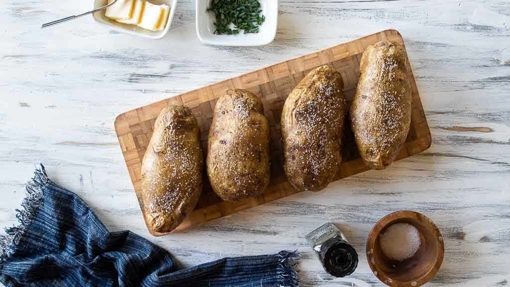 whole baked potatoes seasoned with salt