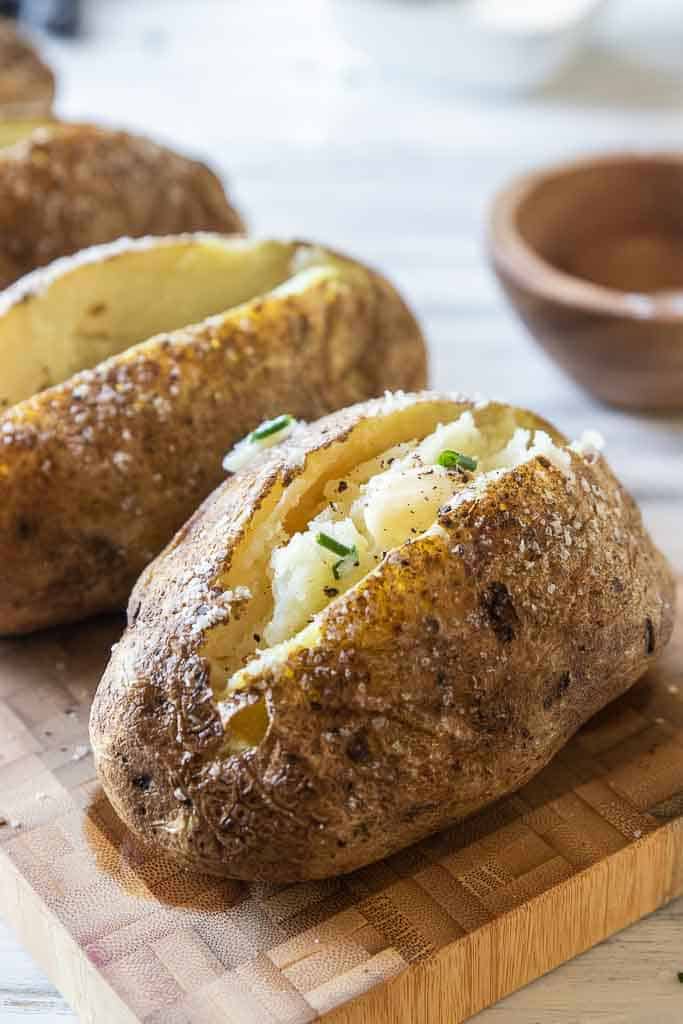 baked potatoes with butter, salt and chives