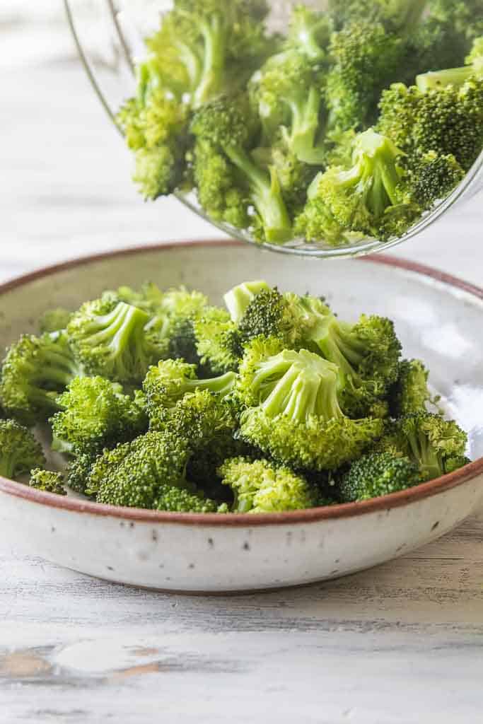 steamed broccoli poured into serving bowl