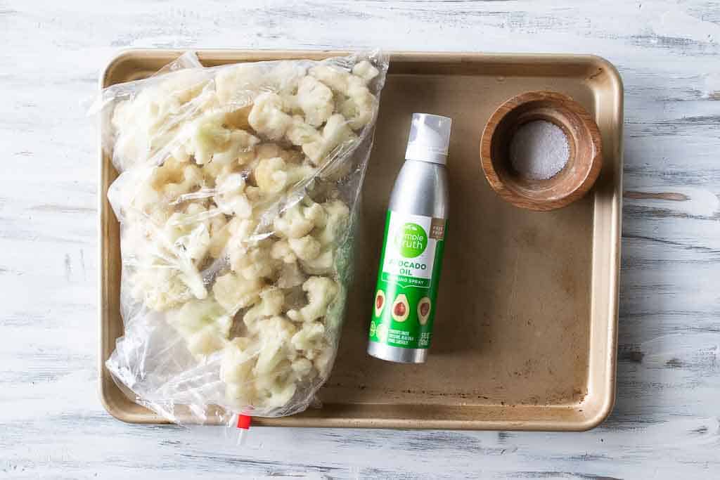 ingredients for roasted frozen cauliflower on sheet pan