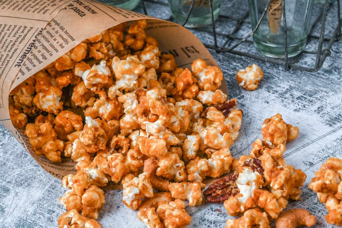 close up view of caramel corn spilling out of paper bag