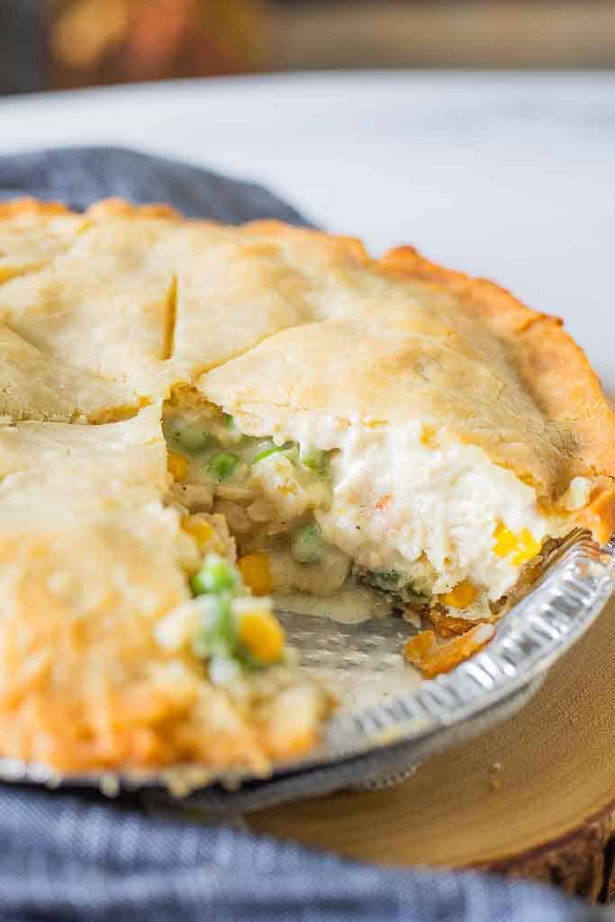 A close up shot of a gluten free chicken pot pie with a slice removed.