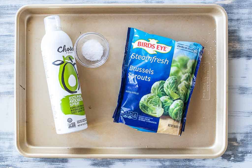 ingredients for roasted frozen brussels sprouts on a sheet pan