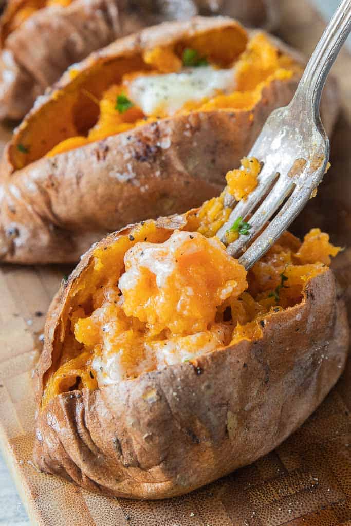 fork scooping into an air fryer sweet potato