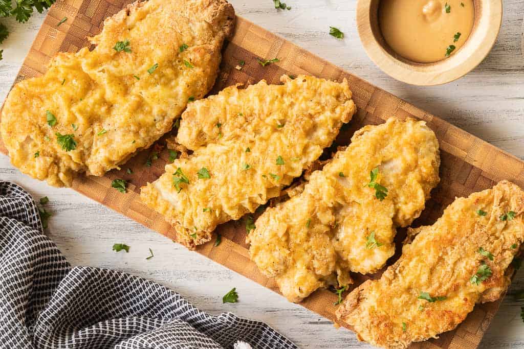 close up view of air fryer chicken cutlets on serving tray