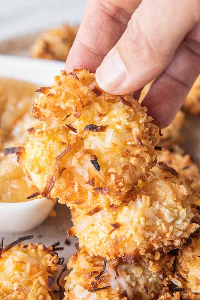 hand holding a coconut shrimp