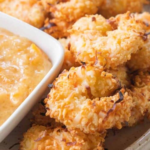 air fryer coconut shrimp on plate with dipping sauce