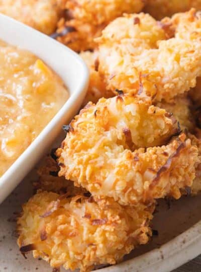 air fryer coconut shrimp on plate with dipping sauce