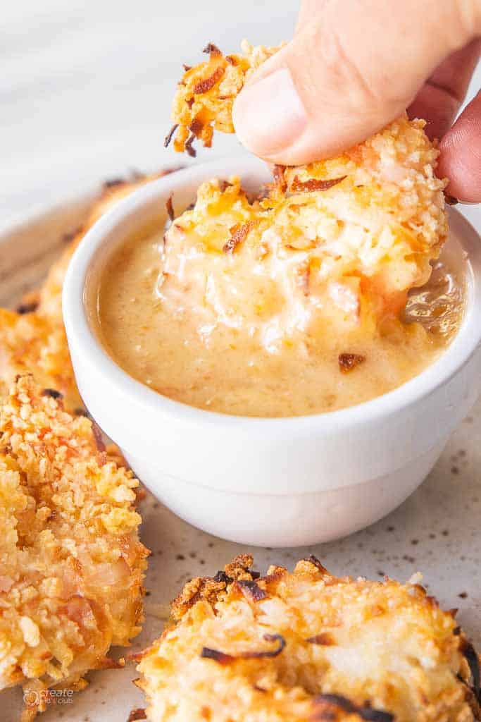 coconut shrimp dipped into sauce