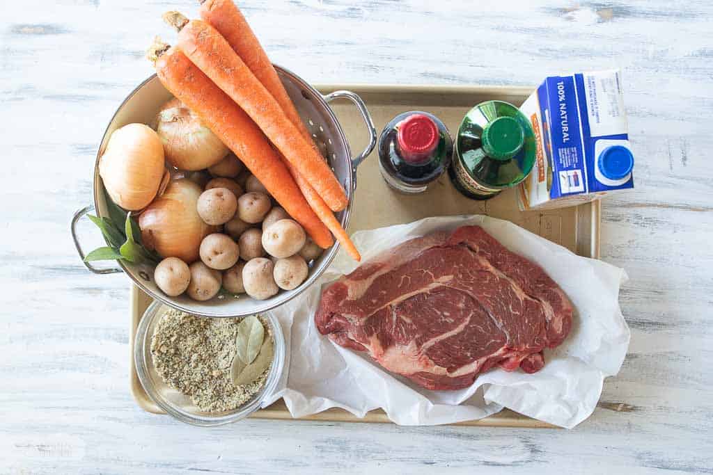 ingredients for chuck roast in oven on baking sheet