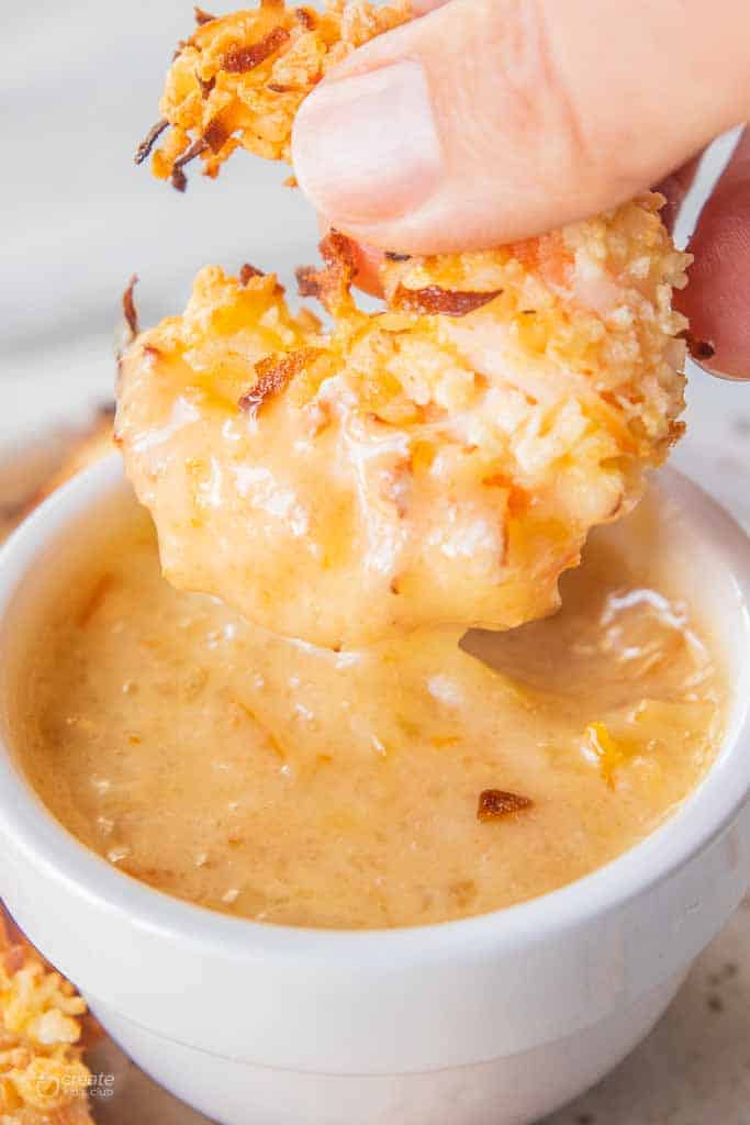 coconut shrimp dipped in dipping sauce